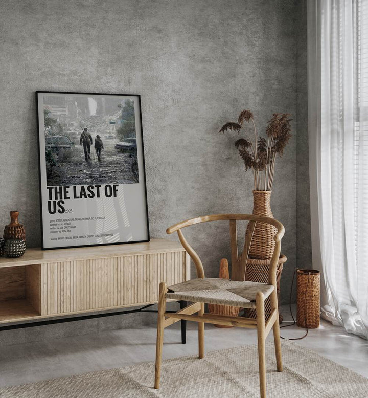 The Last Of Us 2023 Movie Posters in Black Plain Frame placed on a console behind a chair