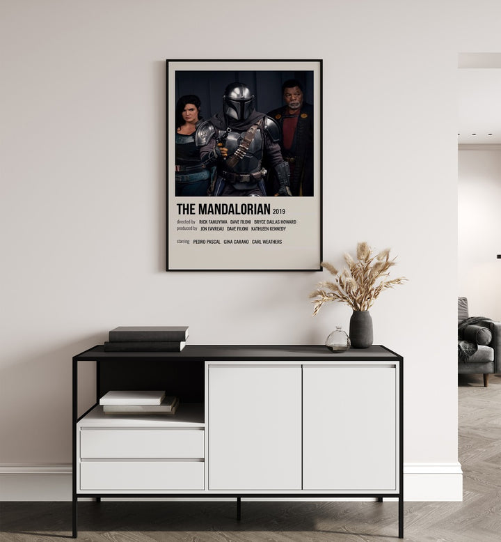 The Mandalorian 2019 iii Movie Posters in Black Plain Frame placed on a white wall behind a table