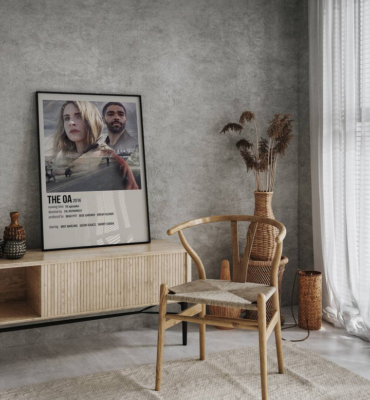 The Oa 2016 Movie Posters in Black Plain Frame placed on a console behind a chair