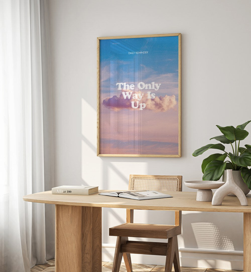 The Only Way Quotes And Typography Posters in Oak Wood Plain Frame placed on a White  Colored Wall near a Study Table in a Workspace in the Drawing Room