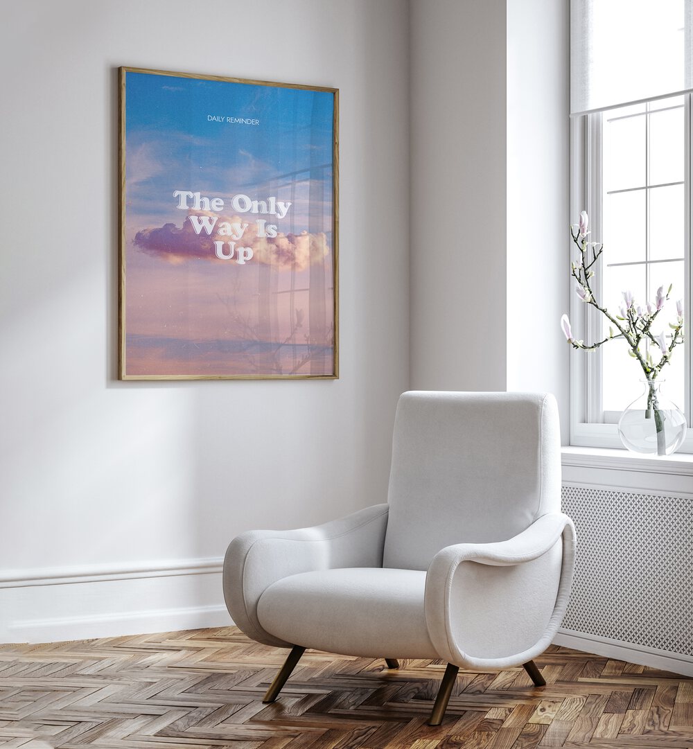 The Only Way Quotes And Typography Posters in Oak Wood Plain Frame placed on a White Colored Wall near a White Sofa Chair in the Drawing Room