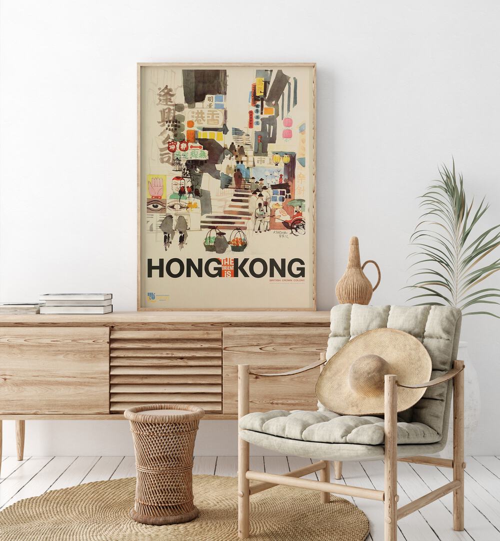 The Orient Is-hong Kong Retro Vintage Travel Travel Posters in Oak Wood Plain Frame on a console table beside a plant