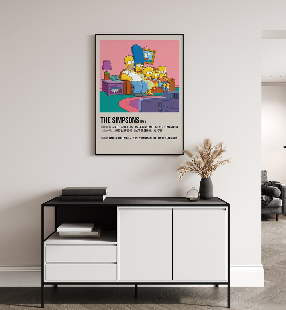 The Simpsons 1989 I Movie Posters in Black Plain Frame placed on a white wall behind a table