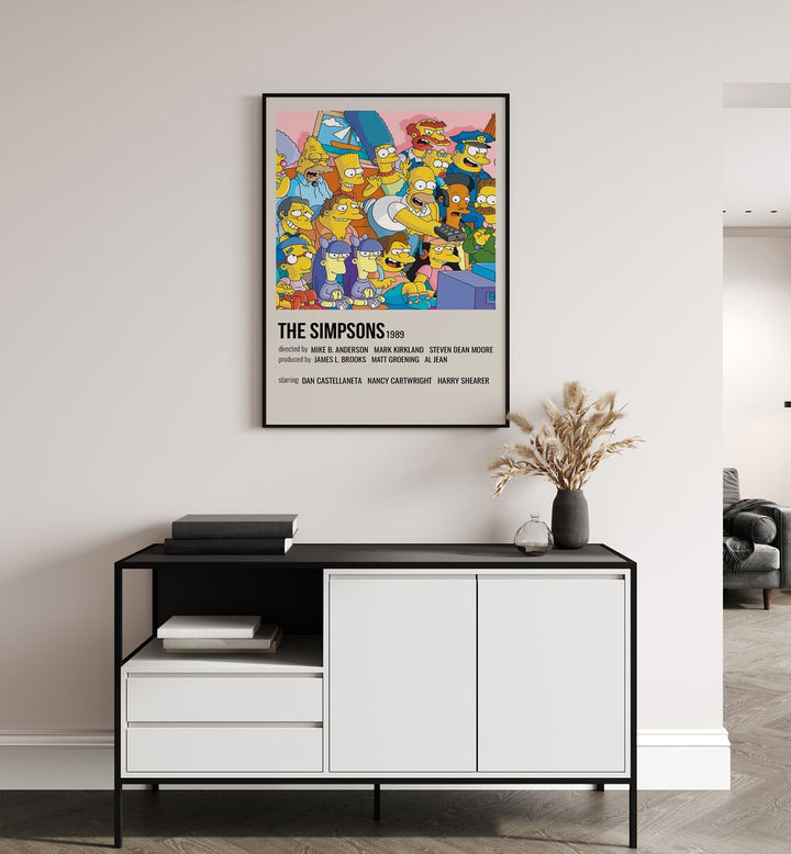 The Simpsons 1989 II Movie Posters in Black Plain Frame placed on a white wall behind a table