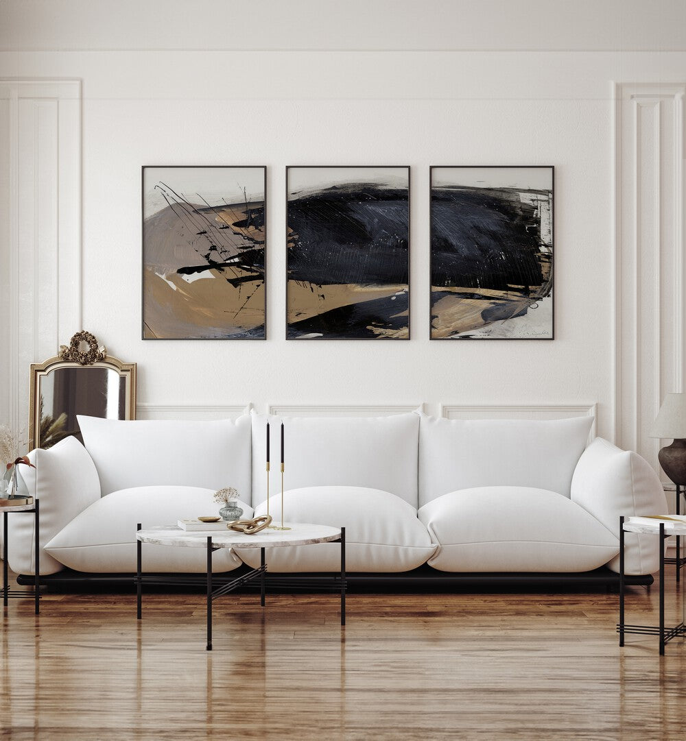 The Snap Abstraction Set Set Of 3 Paintings in Black Plain Frame placed on a living room white wall behind a white sofa 