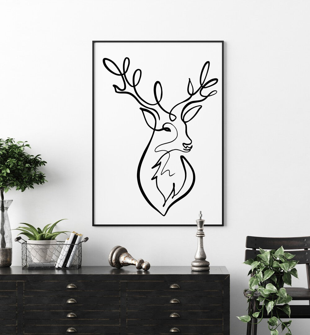 The Stag by Hanna Lee Tidd Line Art Paintings Line Art Prints in Black Plain Frame placed on a wall behind a table