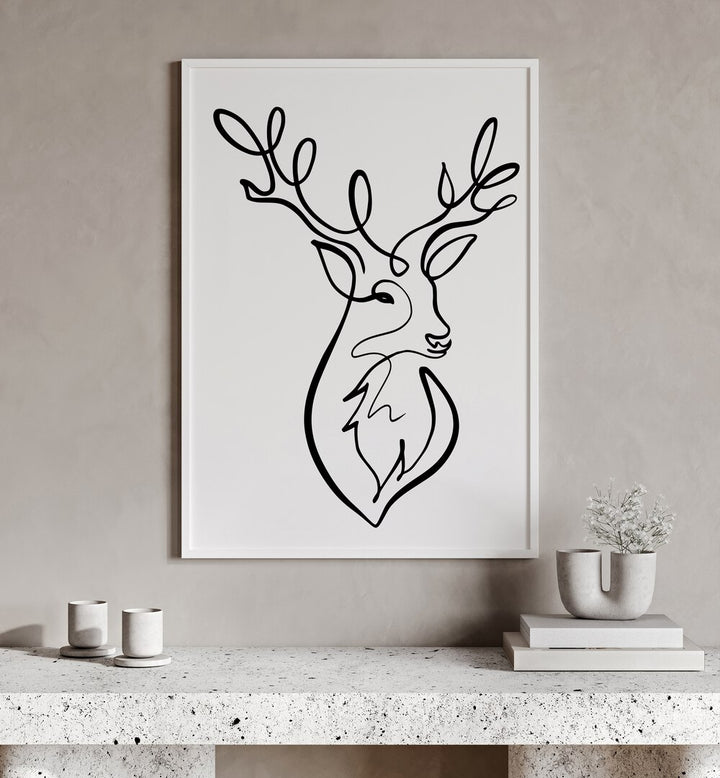 The Stag by Hanna Lee Tidd Line Art Paintings Line Art Prints in White Plain Frame placed on a wall behind a table