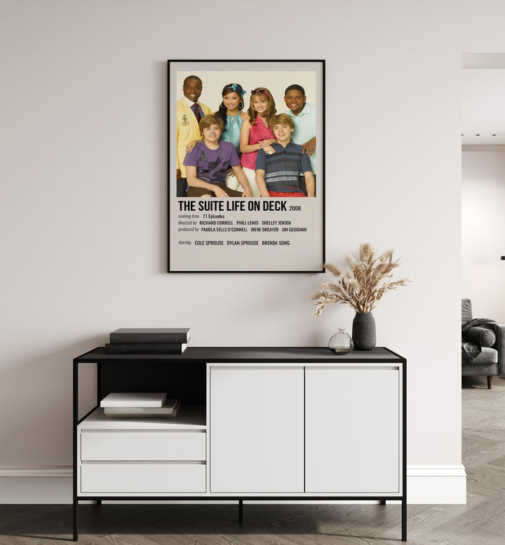 The Suite Life On Deck 2008 Movie Posters in Black Plain Frame placed on a white wall behind a table