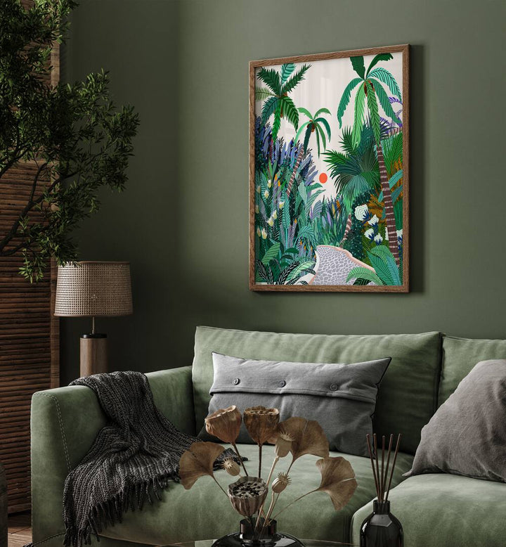 The Urban Jungle Route By Uma Gokhale Botanical Art Prints in Oak Wood Plain Frame behind a green sofa on a wall