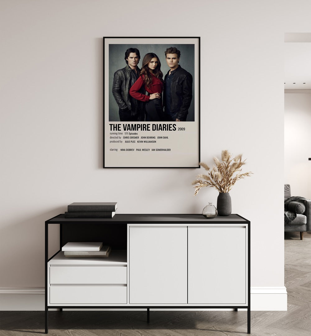 The Vampire Diaries Movie Posters in Black Plain Frame placed on a white wall behind a black and white table