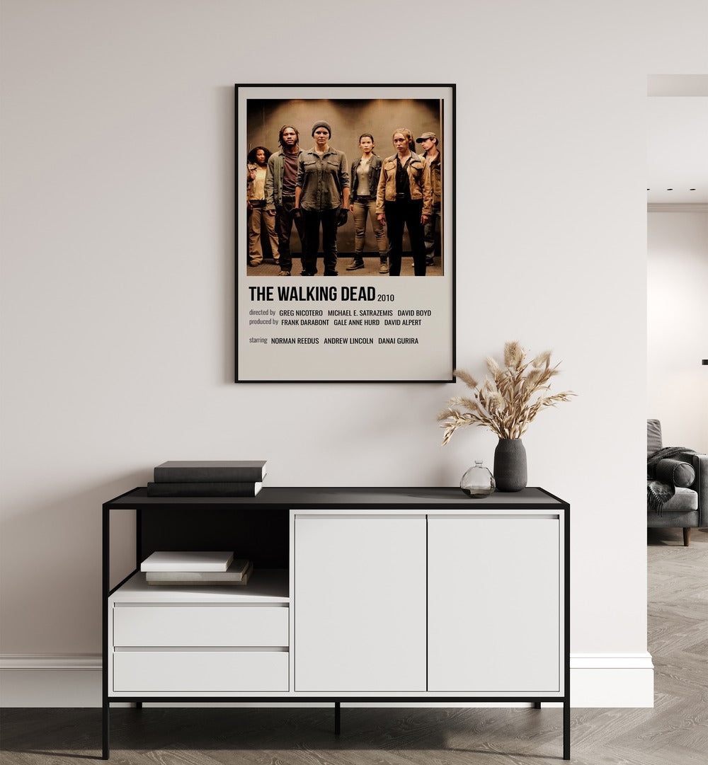 The Walking Dead 2010 I Movie Posters in Black Plain Frame placed on a white wall behind a table