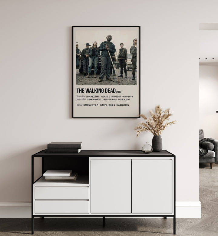 The Walking Dead 2010 II Movie Posters in Black Plain Frame placed on a white wall behind a table