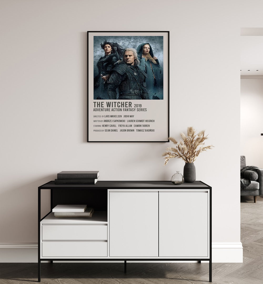 The Witcher 2019 Movie Posters in Black Plain Frame placed on a white wall behind a table