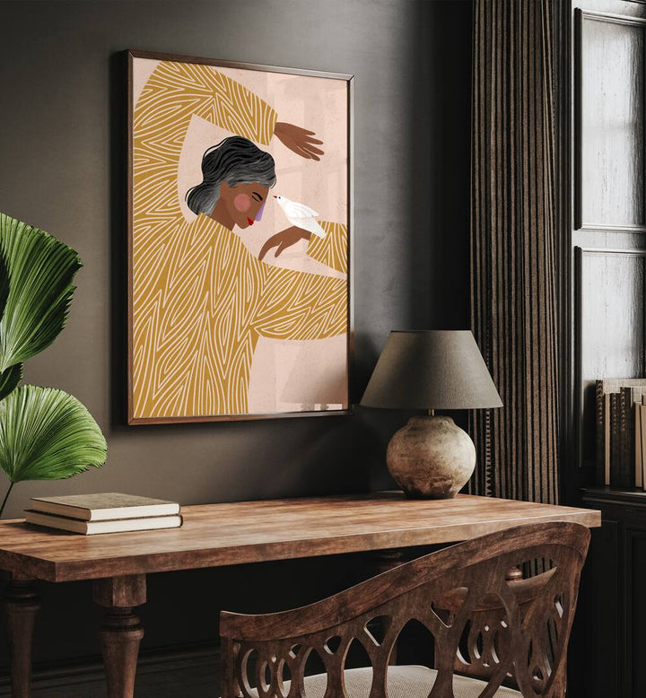 The Woman With Her Bird By Bea Muller Women Illustration Paintings in Dark Wood Plain Frame on a wall above a study table beside a plant