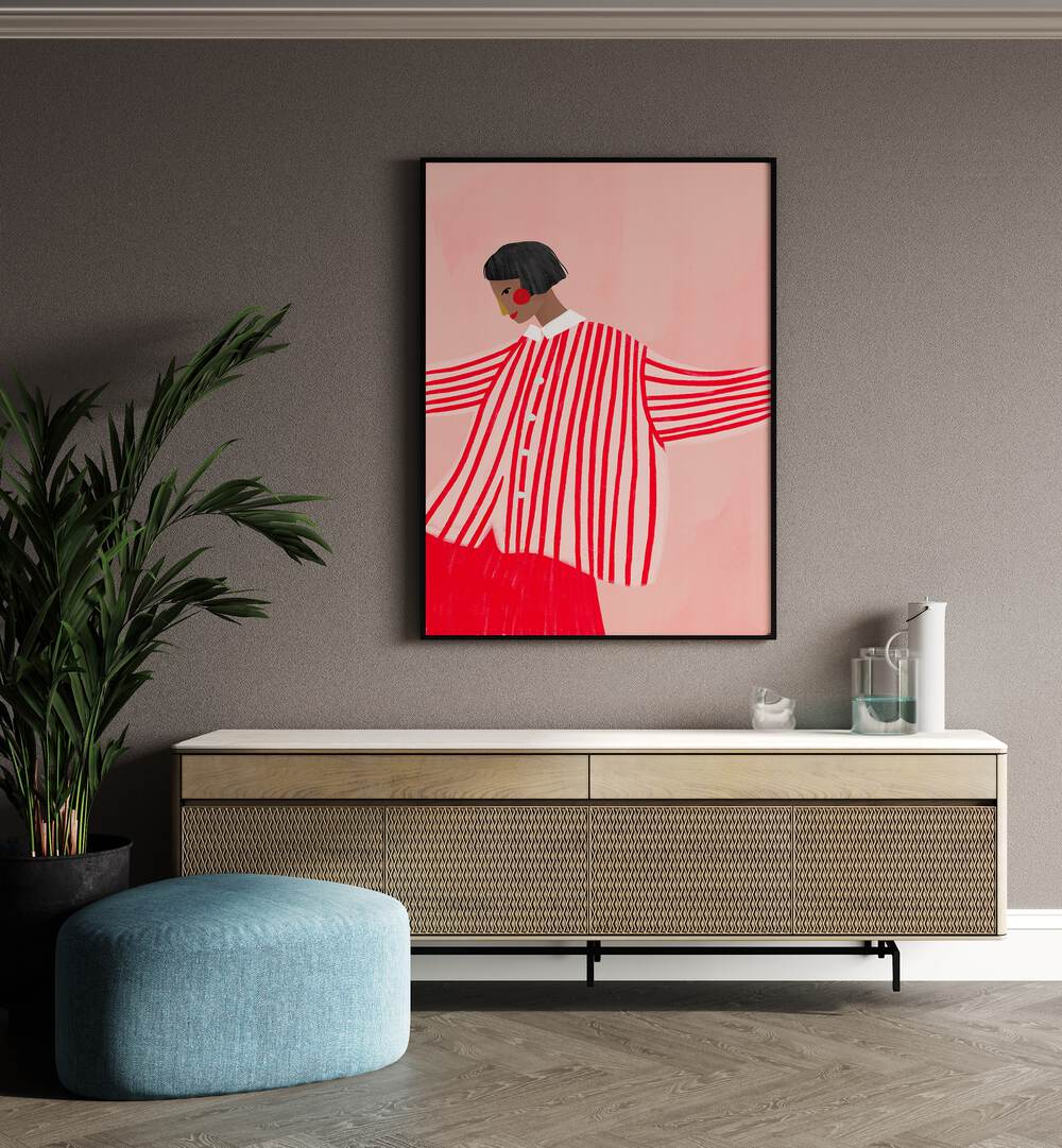 The Woman With Red Stripes By Bea Muller Women Illustration Paintings in Black Plain Frame on a beige wall above a console table beside a plant