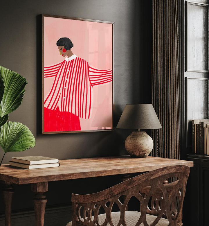 The Woman With Red Stripes By Bea Muller Women Illustration Paintings in Dark Wood Plain Frame on a grey wall above a study table beside a plant