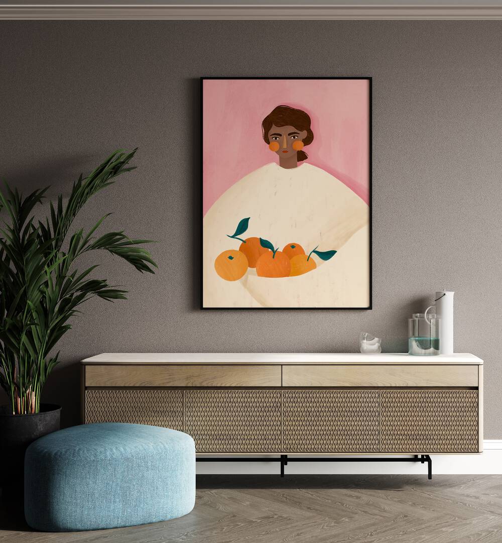 The Woman With the Oranges By Bea Muller Women Illustration Paintings in Black Plain Frame on a beige wall above a console table beside a plant