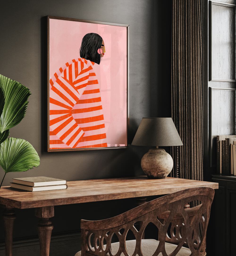 The Woman With the Ornage Stripes By Bea Muller Women Illustration Paintings in Dark Wood Plain Frame on a wall above a study table beside a plant