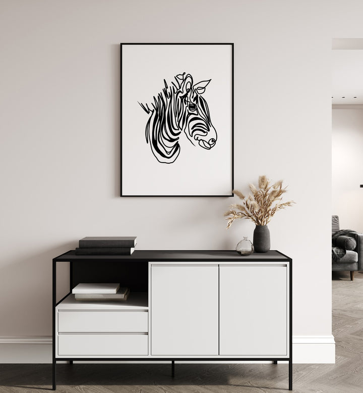 The Zebra by Hanna Lee Tidd Line Art Paintings Line Art Prints in Black Plain Frame placed on a wall behind a table