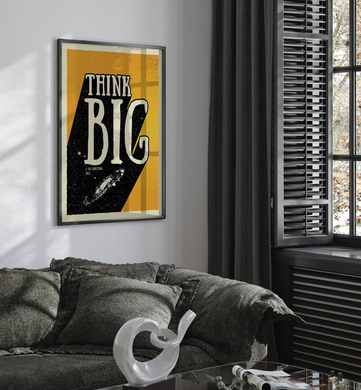 Think Big Quotes and Typography Posters in Black Plain Frame placed on a wall behind a sofa and beside a window