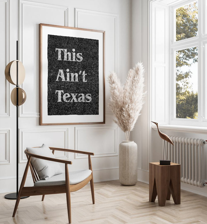 This Aint Texas Quotes And Typography Posters in Dark Wood Plain Frame placed on a White Colored Wall in the Drawing Room