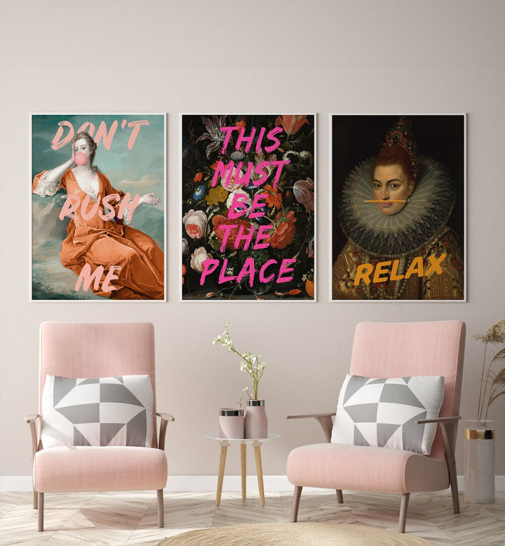 This Must Be The Place Set Set Of 3 Paintings in White Plain Frame placed on a wall behind two pink chairs and a table