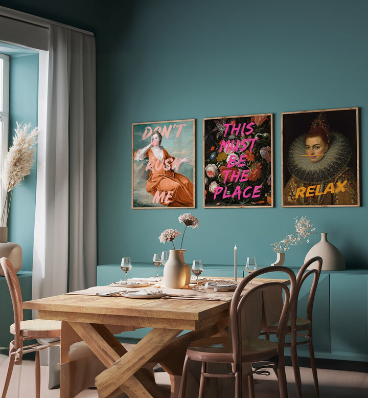 This Must Be The Place Set Set Of 3 Paintings in Oak Wood Plain Frame placed on a teal green wall beside a dining table and a window for dining area