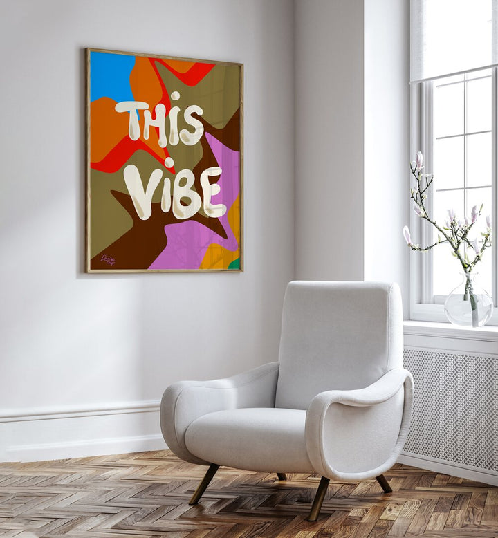 This Vibe Wall Art Prints in Oak Wood Plain Frame placed on a White Colored Wall near a White Sofa Chair in the Drawing Room