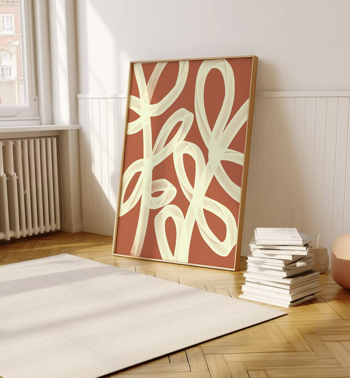 Ties by Yopie Studio Abstract Paintings Abstract Art Prints in Oak Wood Plain Frame placed on the floor between a stack of books and a window