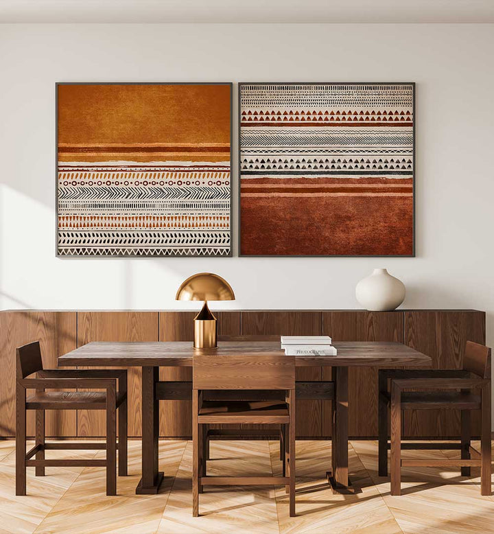 Dining room with wooden table and chairs, and two framed artworks on the wall.