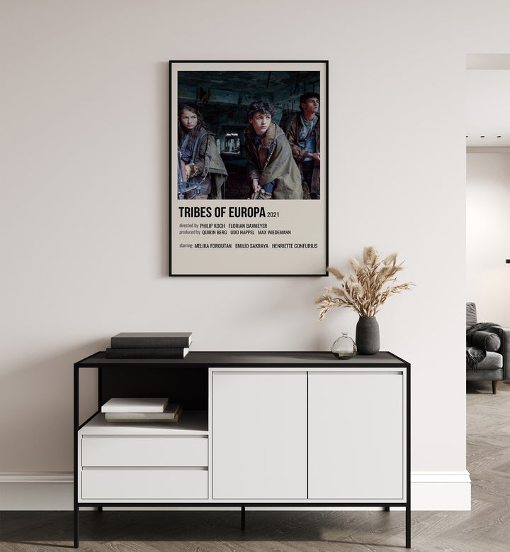 Tribes Of Europa 2021 Movie Posters in Black Plain Frame placed on a white wall behind a table