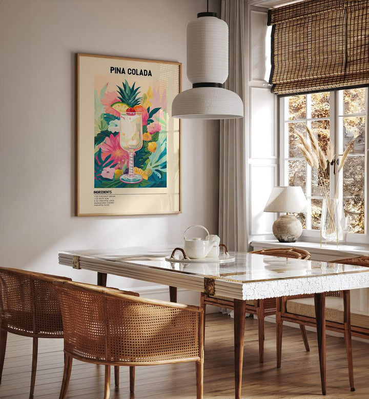 Tropical Pina Colada Cafe Art Prints Cafe Posters in Oak Wood Plain Frame placed on a wall in a dining room area beside a window and behind a dining table