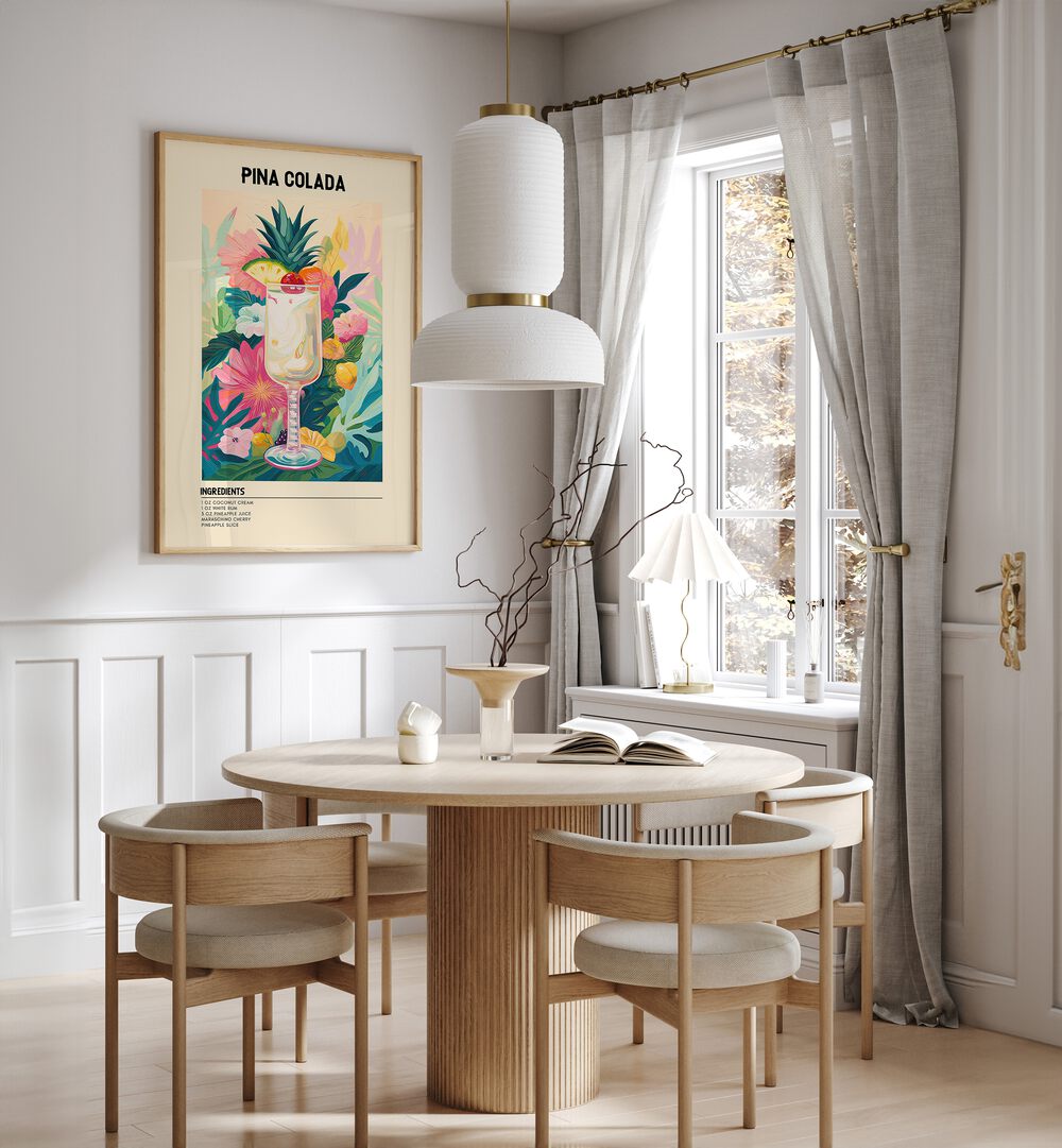 Tropical Pina Colada Cafe Art Prints Cafe Posters in Oak Wood Plain Frame placed on a wall in a dining room area beside a window and behind a dining table