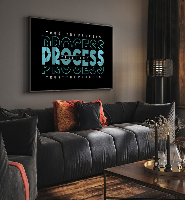 Trust the Process Quotes and Typography Posters in Black Plain Frame placed on a wall in living room behind a sofa