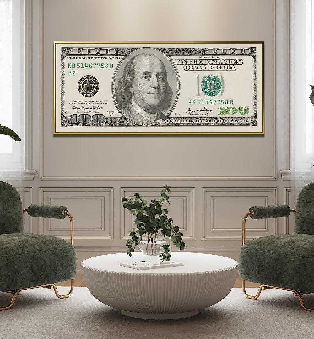 Us Dollar II Money Art Artwork in Gold Floater Frame Placed on a Cream Colored Wall Near Luxurious Green Sofa Chairs in a Luxurious Living Room