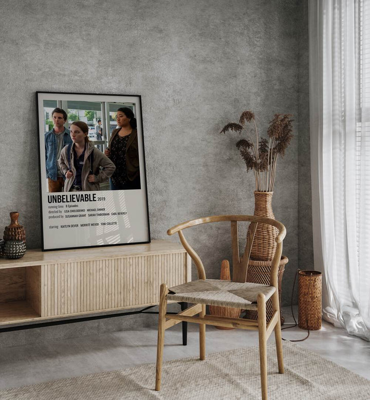 Unbelievable 2019 Movie Posters in Black Plain Frame on a console table behind a chair