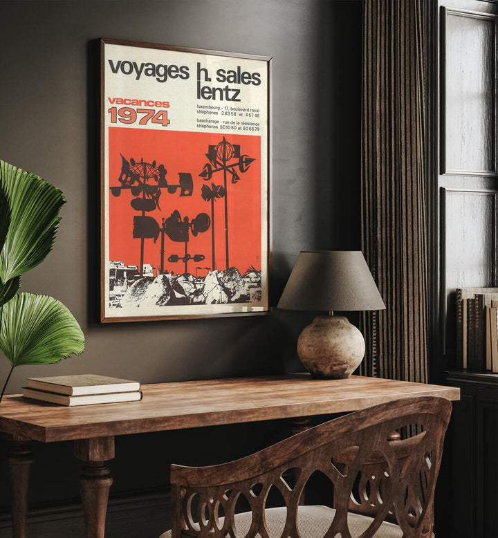 Vacances-1974 Retro Vintage Travel Travel Posters in Dark Wood Plain Frame on a wall above a study table beside a lamp