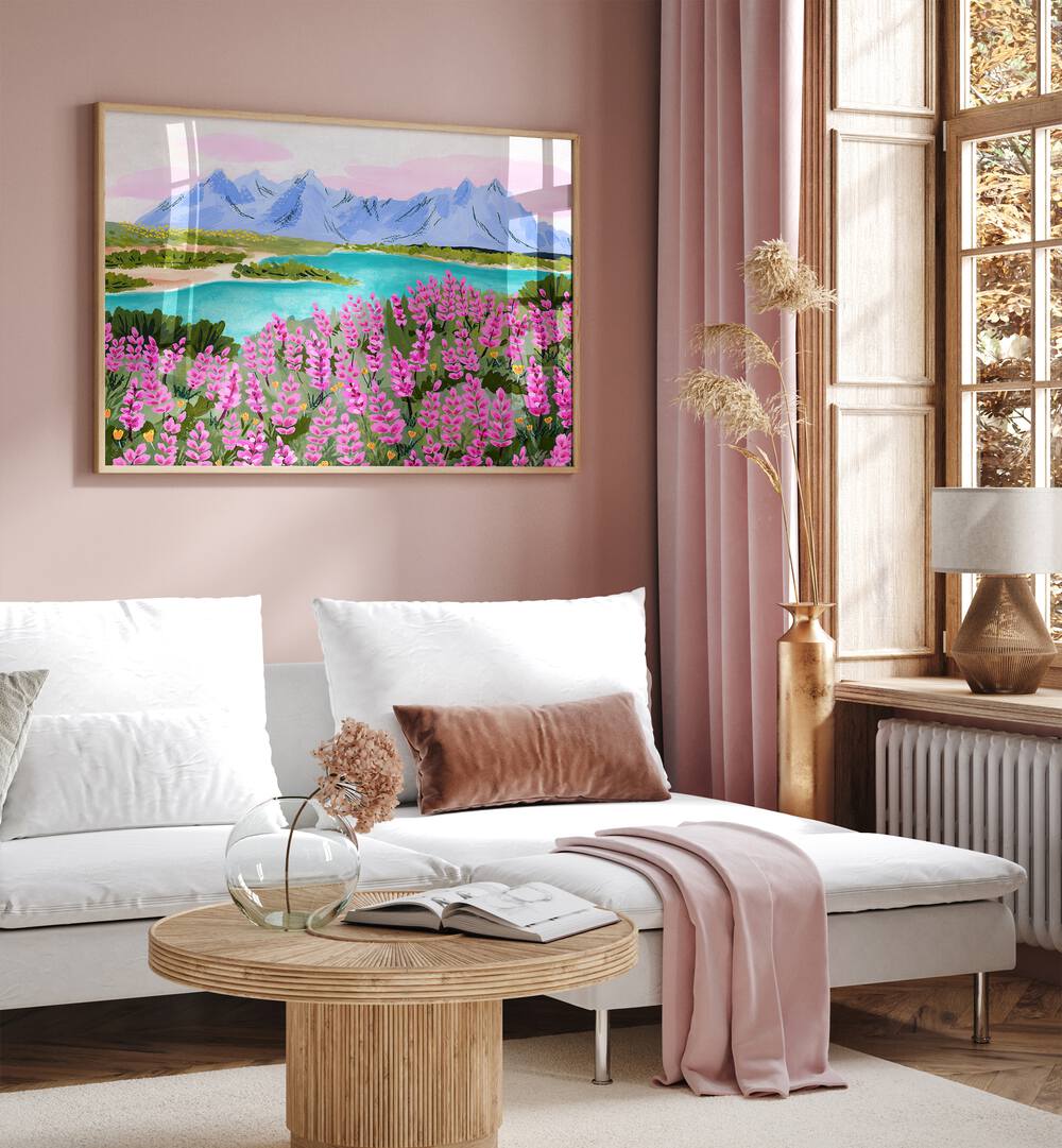 Vestrahorn By Sarah Gesek Landscape Art Prints in Oak Wood Plain Frame placed on a pink wall beside a window and behind a sofa for living room