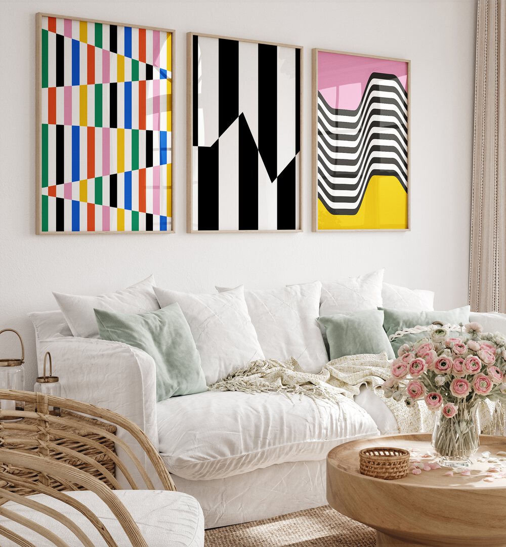 Vibrant Colors Set Set Of 3 Paintings in Oak Wood Plain Frame placed on a living room wall behind a sofa