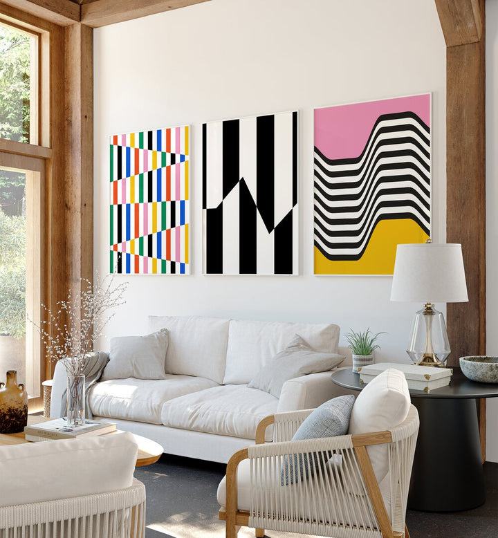 Vibrant Colors Set Set Of 3 Paintings in White Plain Frame placed on a living room wall behind a sofa