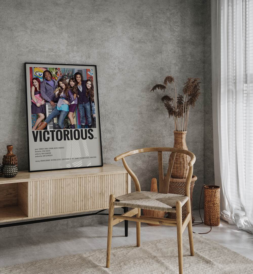 Victorious 2010 Movie Posters in Black Plain Frame placed on a console table behind a chair