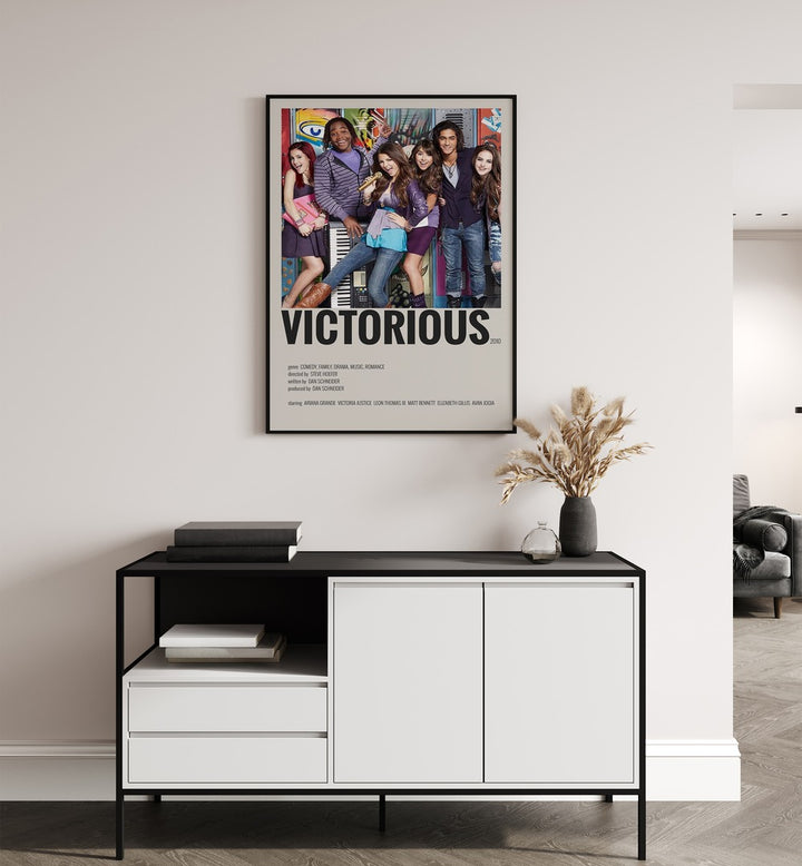 Victorious 2010 Movie Posters in Black Plain Frame placed on a white wall behind a table