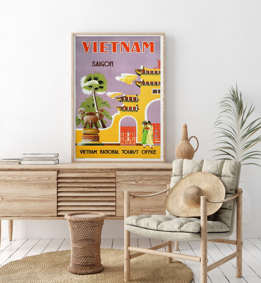 Vietnam National Tourist Office  Vintage Travel Posters in Oak Wood Plain Frame placed on a console table behind a chair