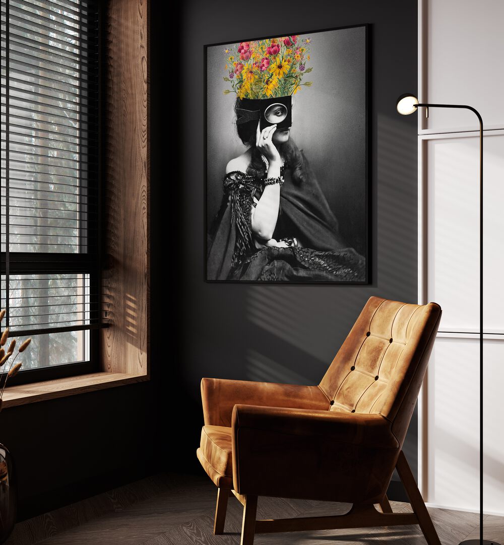 Vintage Woman With Flowers by the Art Concept Altered Art Prints in Black Plain Frame placed on a wall beside a orange sofa