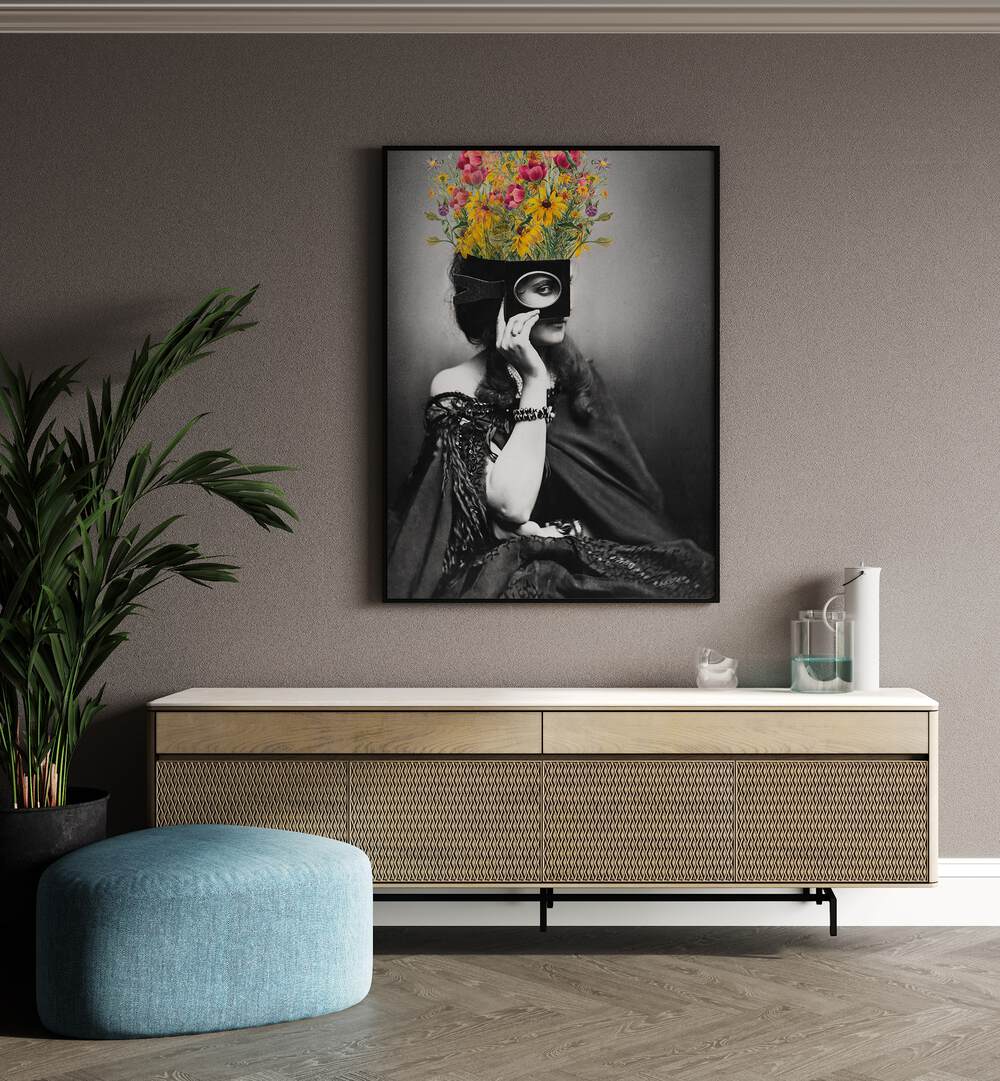 Vintage Woman With Flowers by the Art Concept Altered Art Prints in Black Plain Frame placed on a wall behind a console table