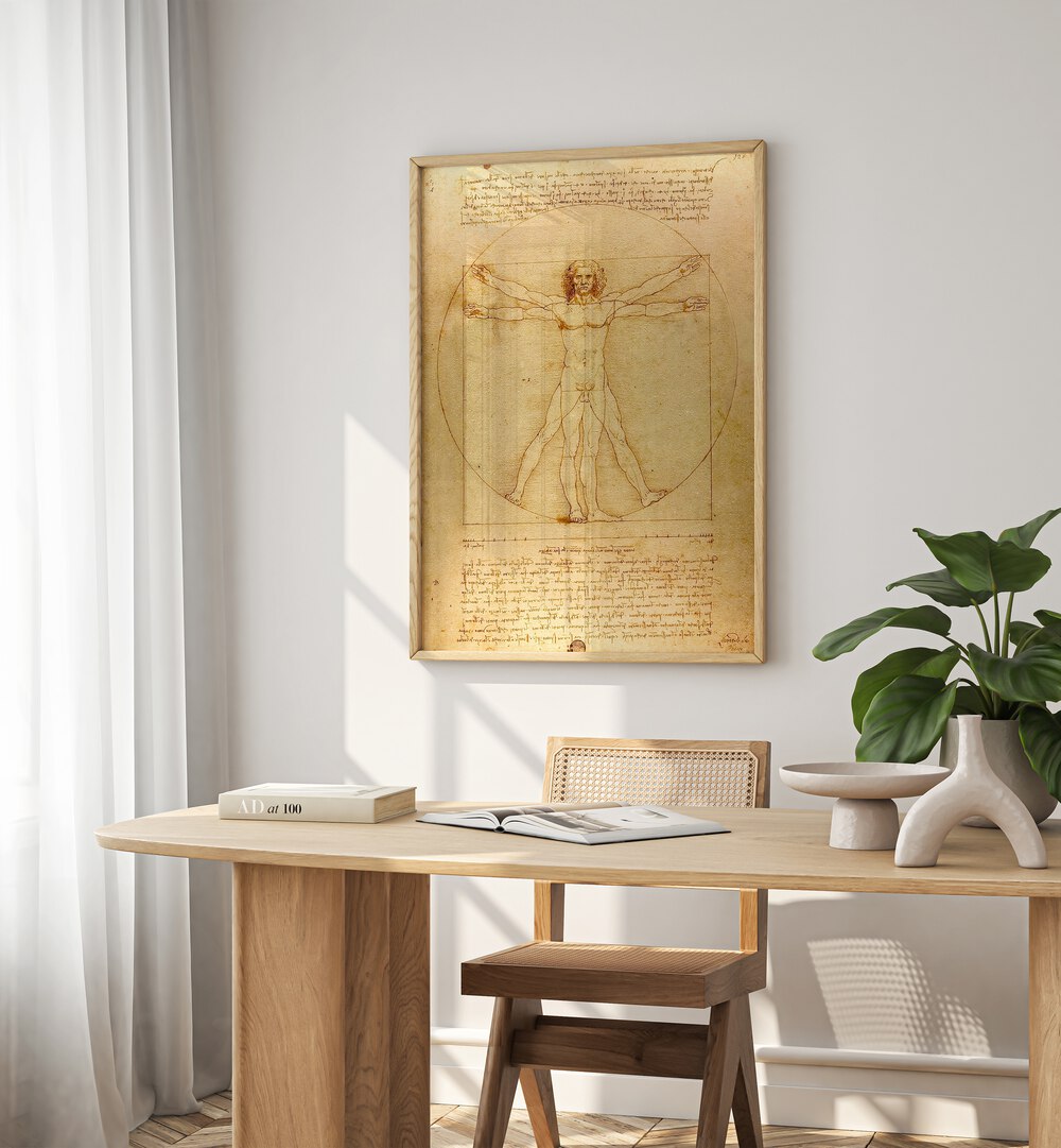 Vitruvian Man Vintage Paintings in Oak Wood Plain Frame placed on a white wall behind a study table and beside a window