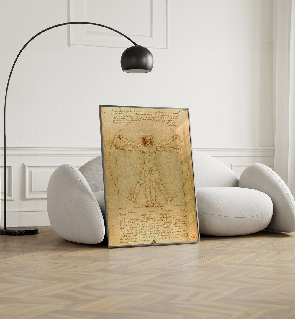 Vitruvian Man Vintage Paintings in Black Plain Frame placed on the floor beside a sofa