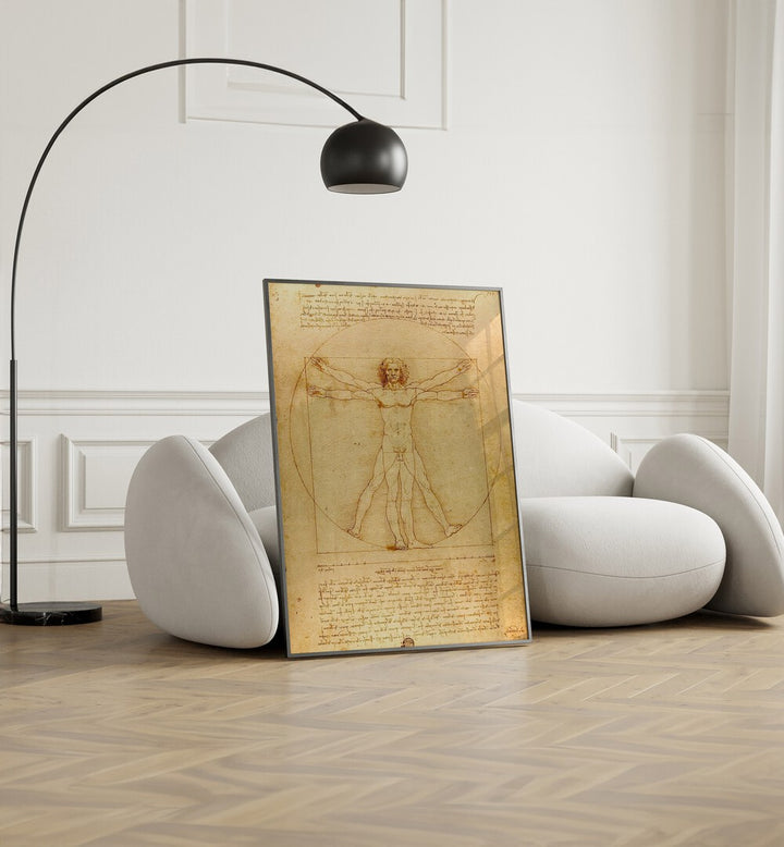 Vitruvian Man Vintage Paintings in Black Plain Frame placed on the floor beside a sofa