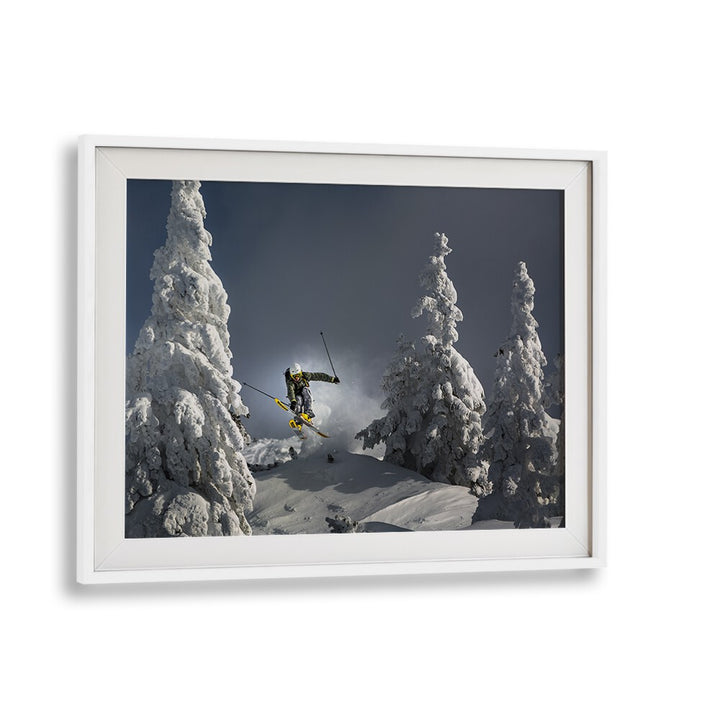 Skiing through snowy trees in an action shot from the SKI IS LIFE, PHOTOGRAPHY PRINTS collection. Perfect for winter lovers!