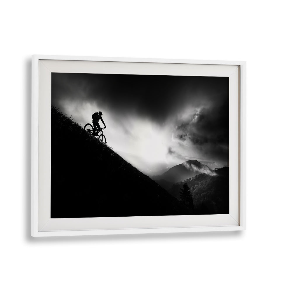 Silhouette of a cyclist on a mountain at dawn, featured in SUNRISE RIDE, PHOTOGRAPHY PRINTS collection.